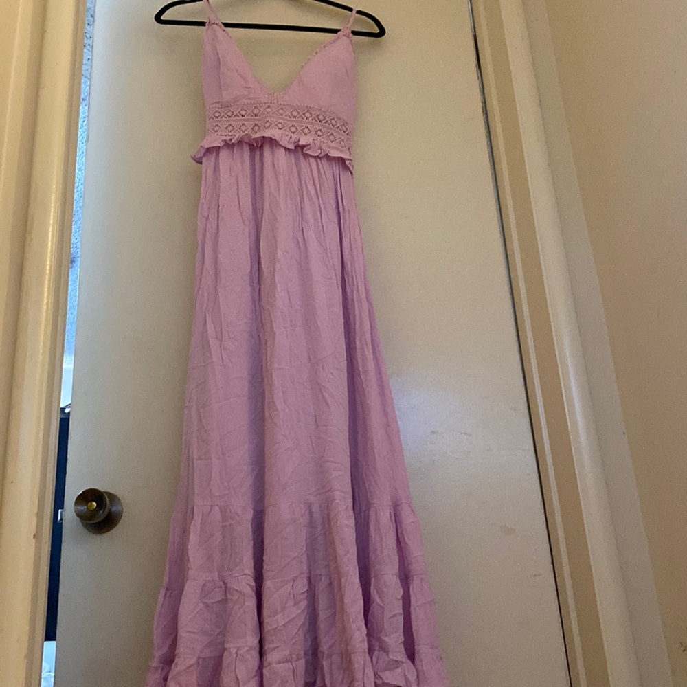 long lavender dress with a floral lace detail and a cross back